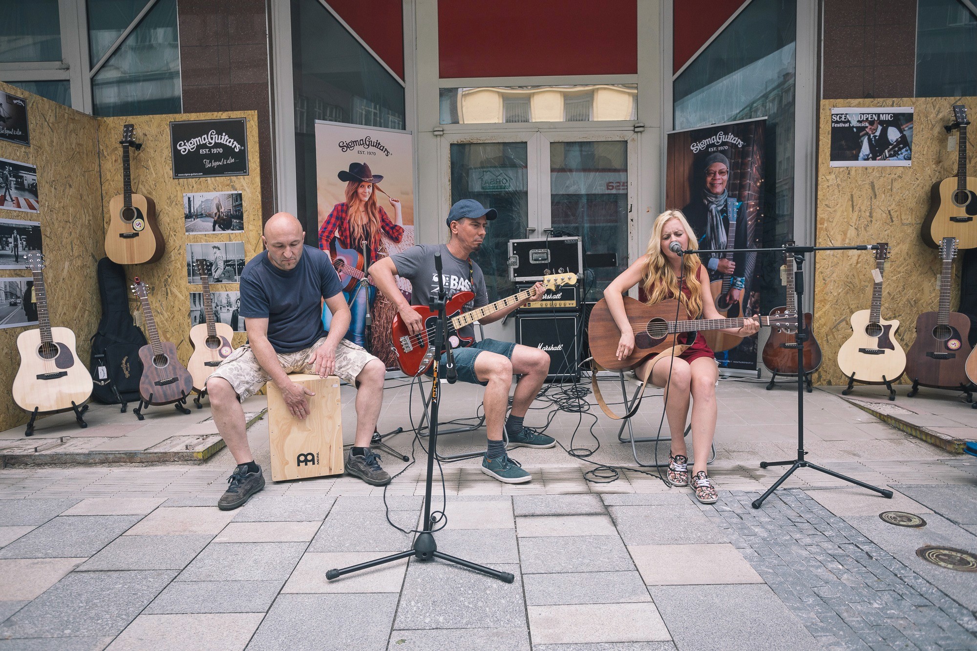 Musicians performing close to listeners in a city street.