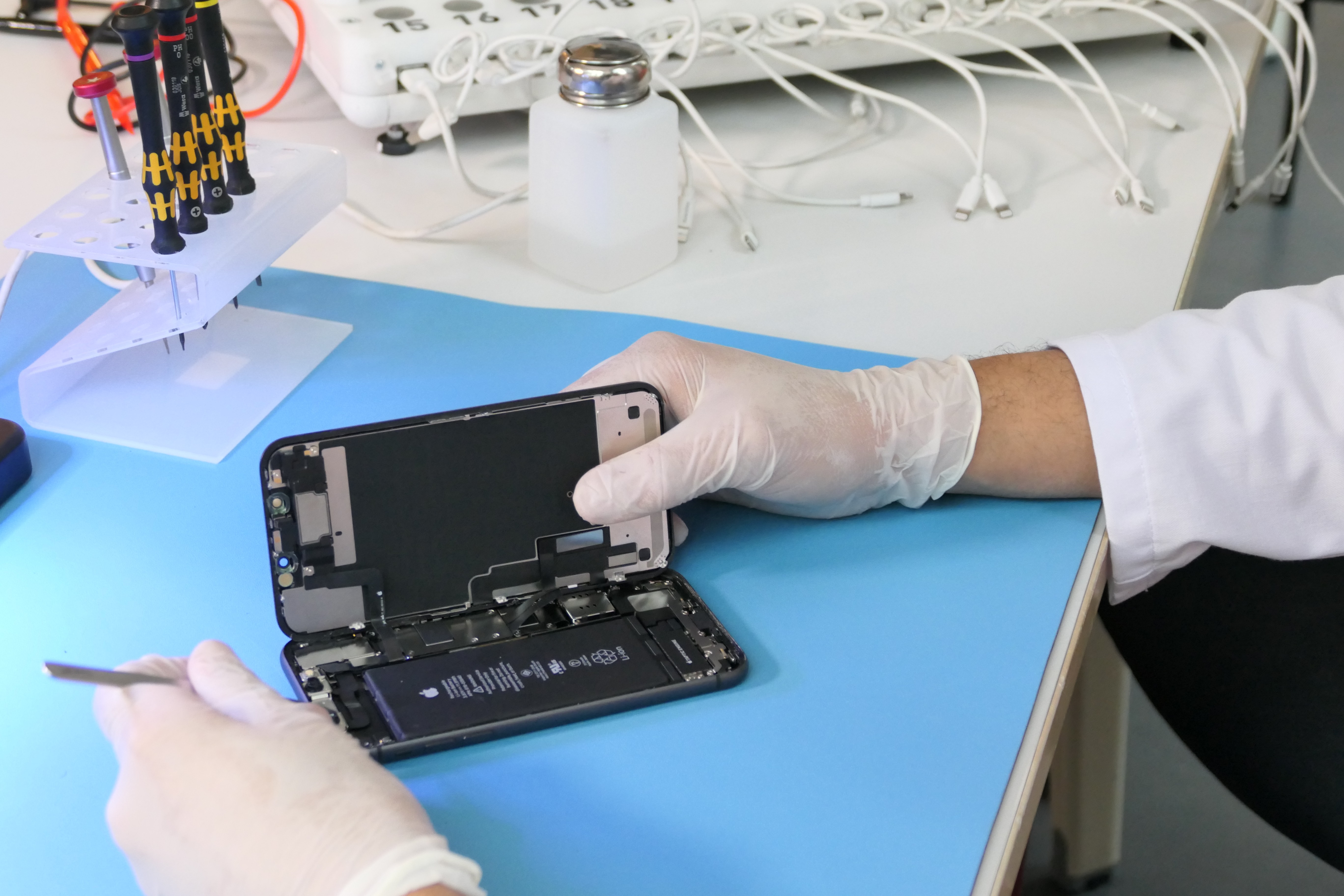 Technician refurbishing a smartphone 