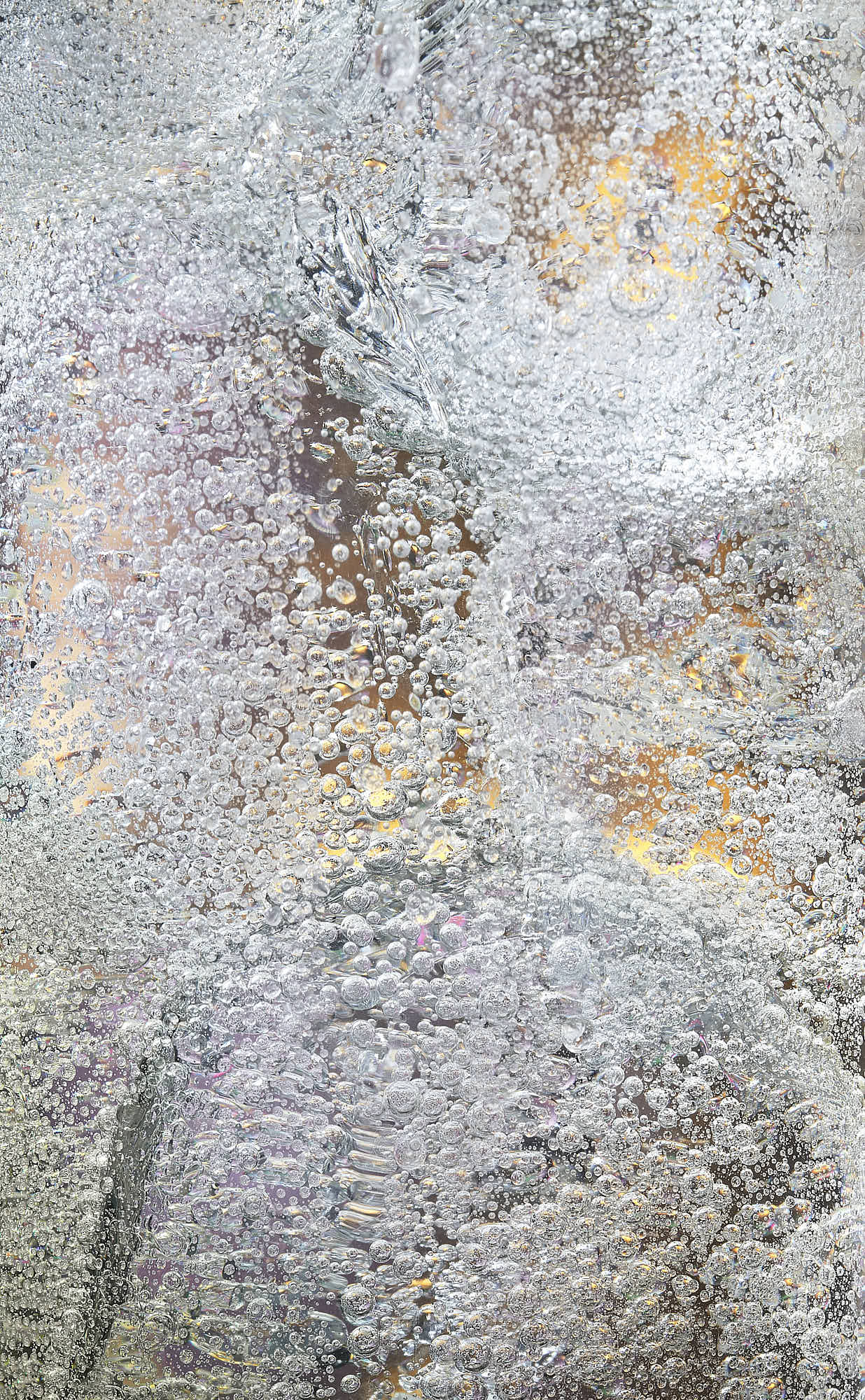Abstract detail of cocktail with ice cubes and bubbles