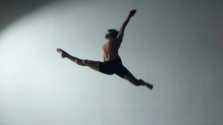 A male jumping during a dance move