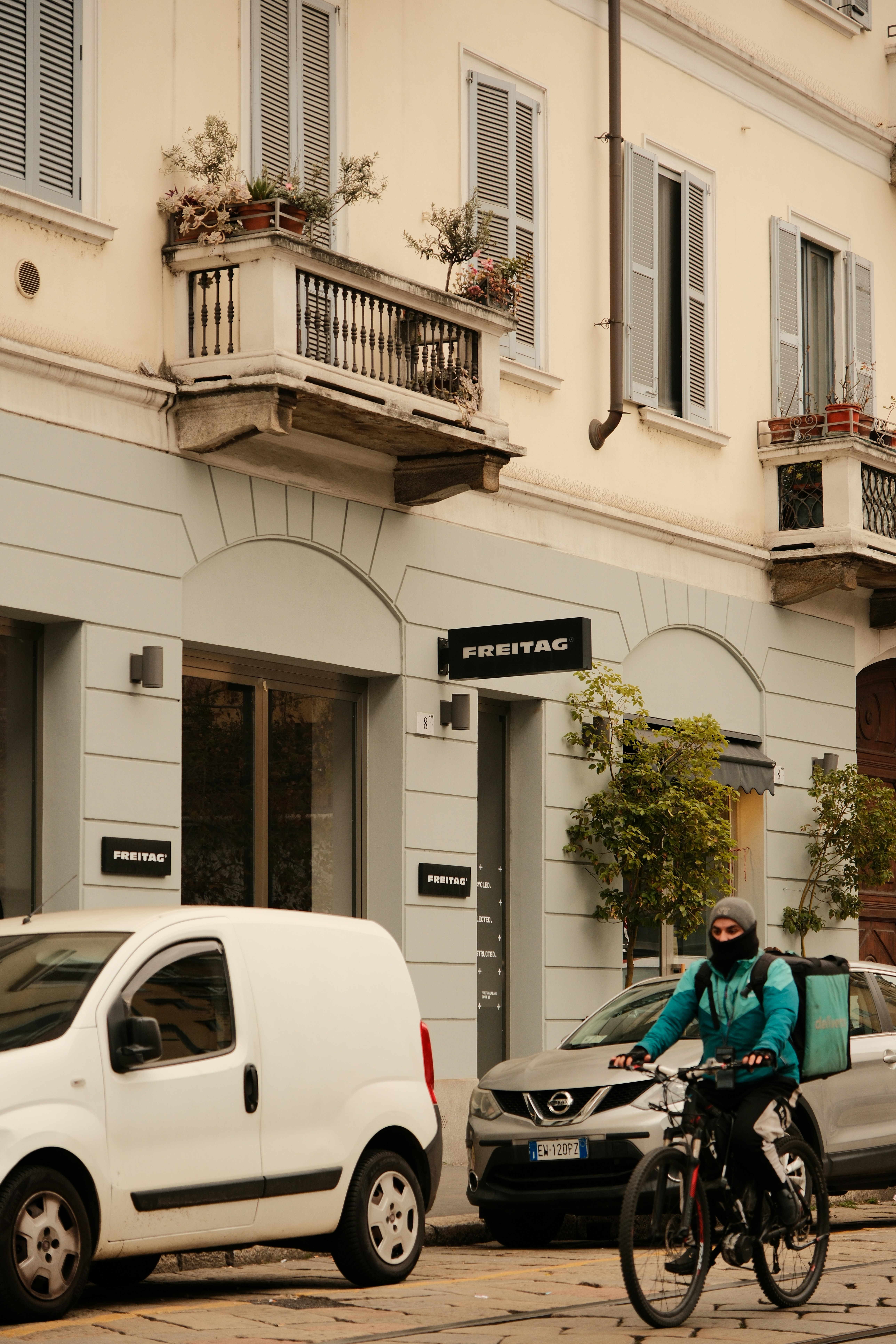 A cyclist rides past the freitag shop.
