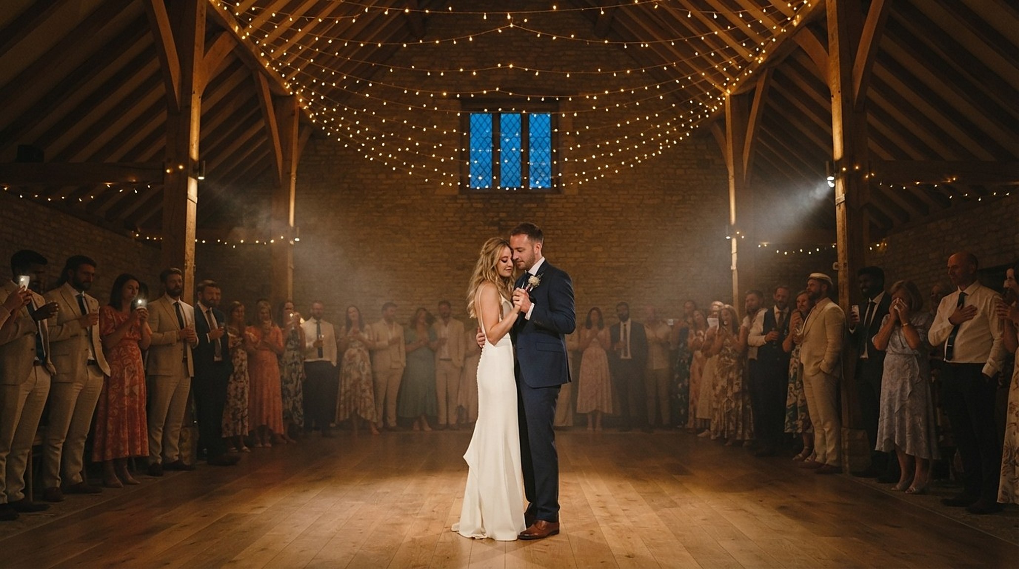 The bride and groom's first dance under festoon lights