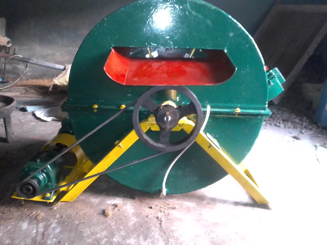 Front-facing McMellion PK-DMS prototype showing its separation drum, feed opening, belt drive and electric motor.