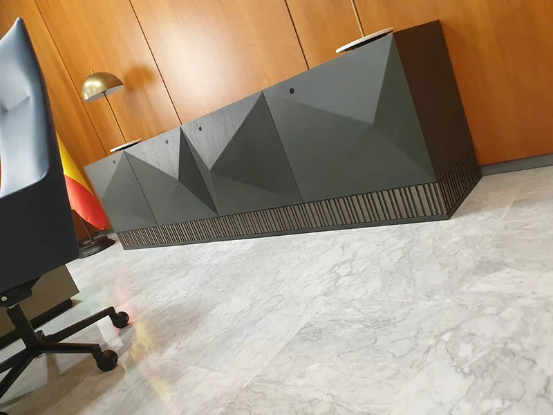 Golden cross atop a domed building with blue sky.