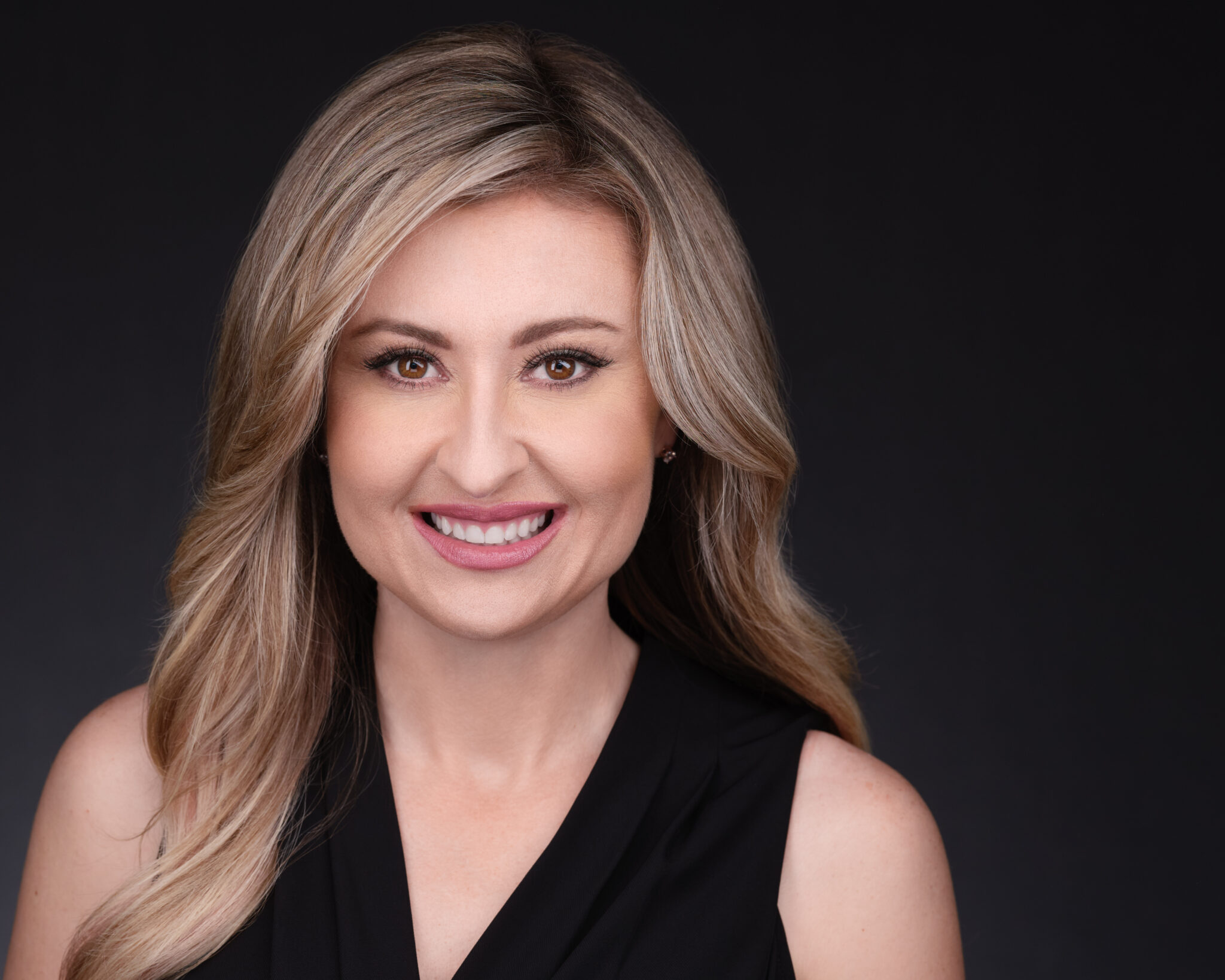 A man standing in front of a window smiling