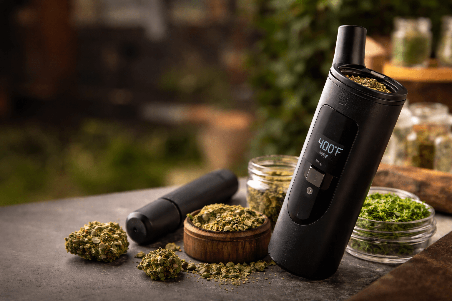 Sleek dry herb vaporizer with ground cannabis and accessories on a countertop