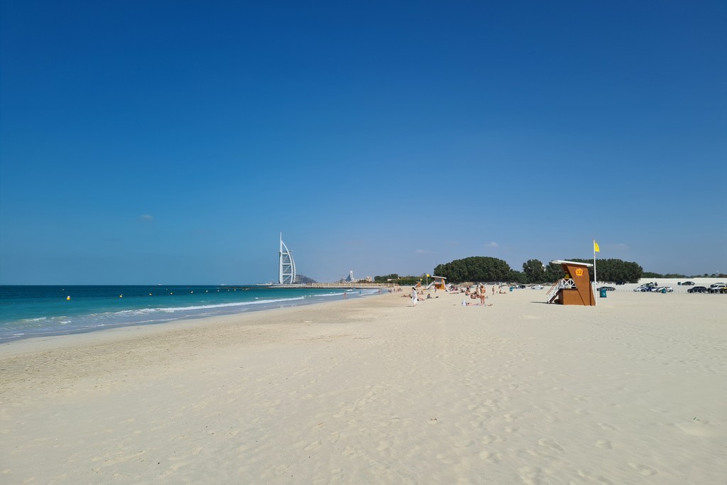 Al Sufouh Beach near Springs 11, featuring golden sands, gentle waves, and a clear blue sky, ideal for relaxation and recreation.