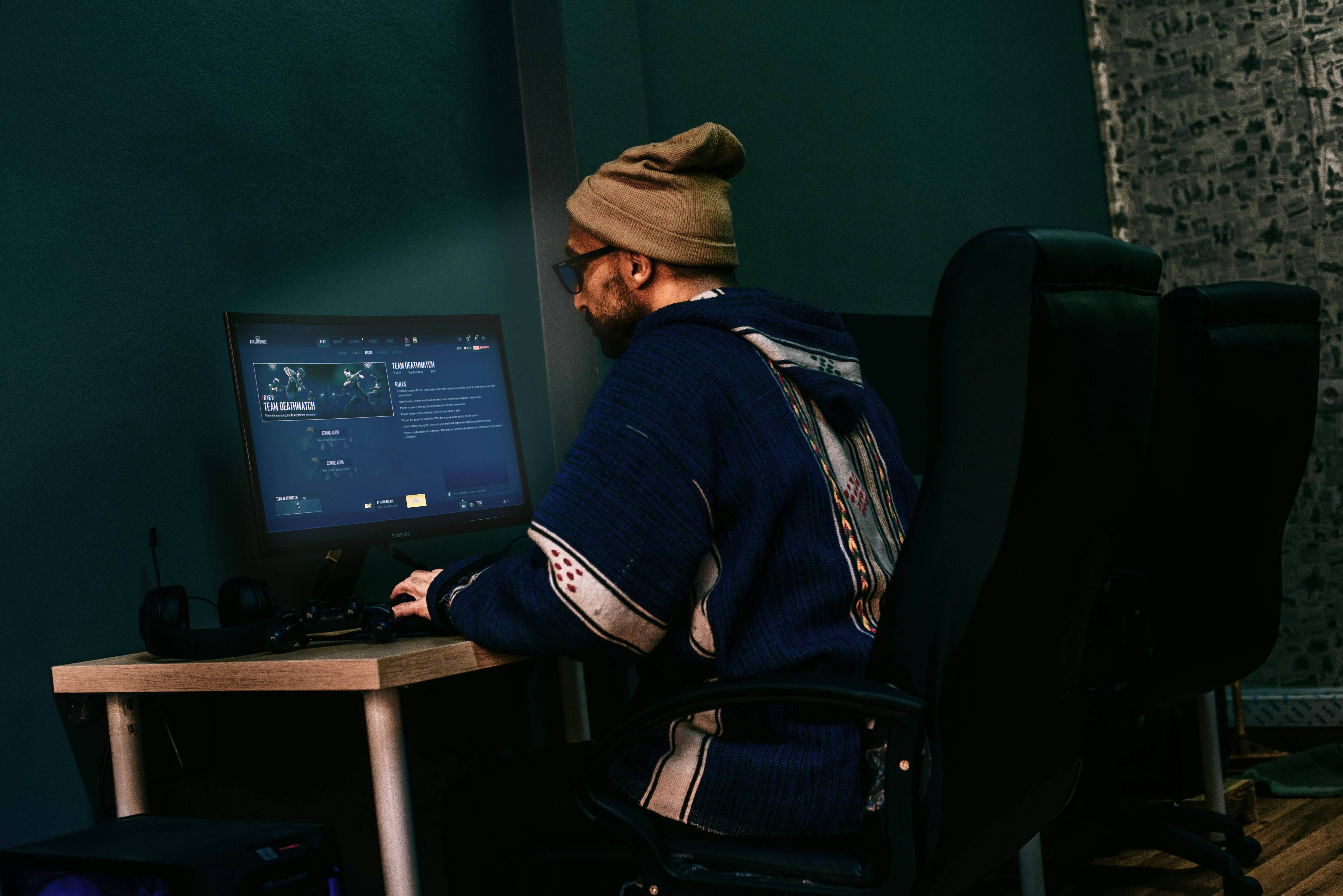 a man sitting in front of a computer monitor