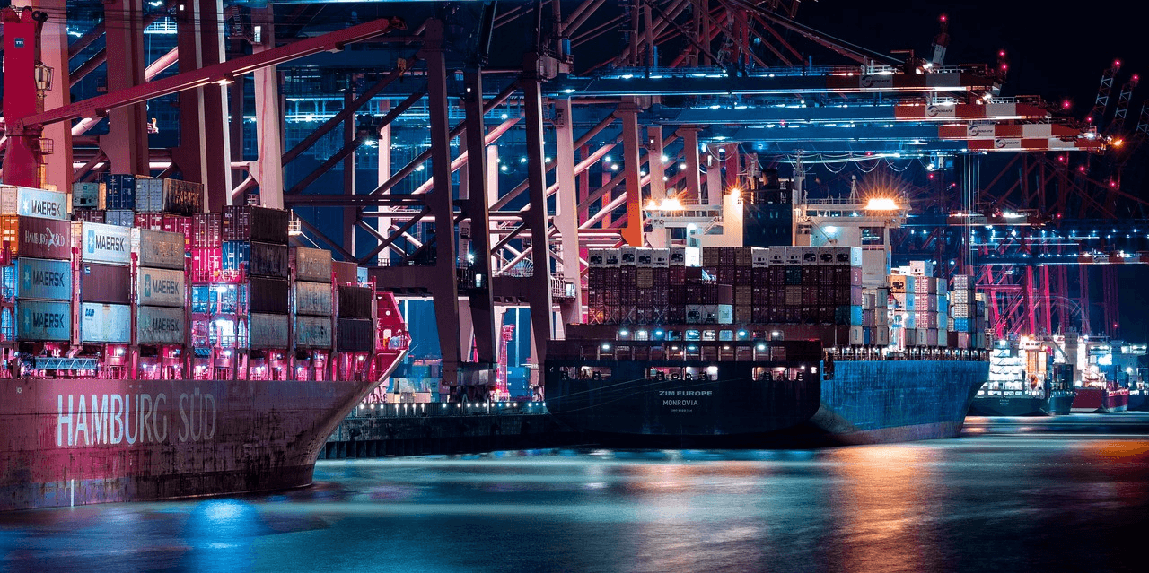 Large container ships stacked with containers, moored at a port