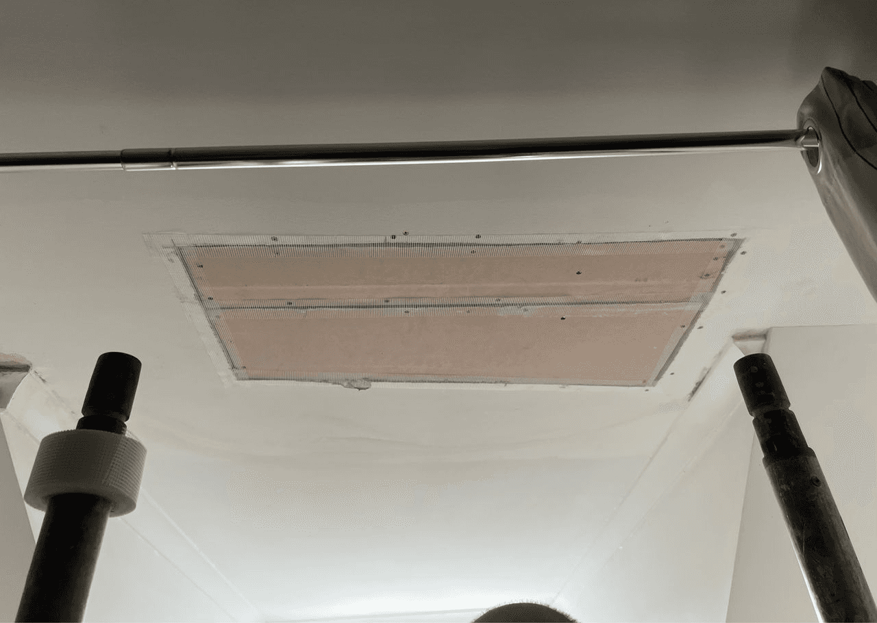 Construction workers installing roof tiles on a new building.