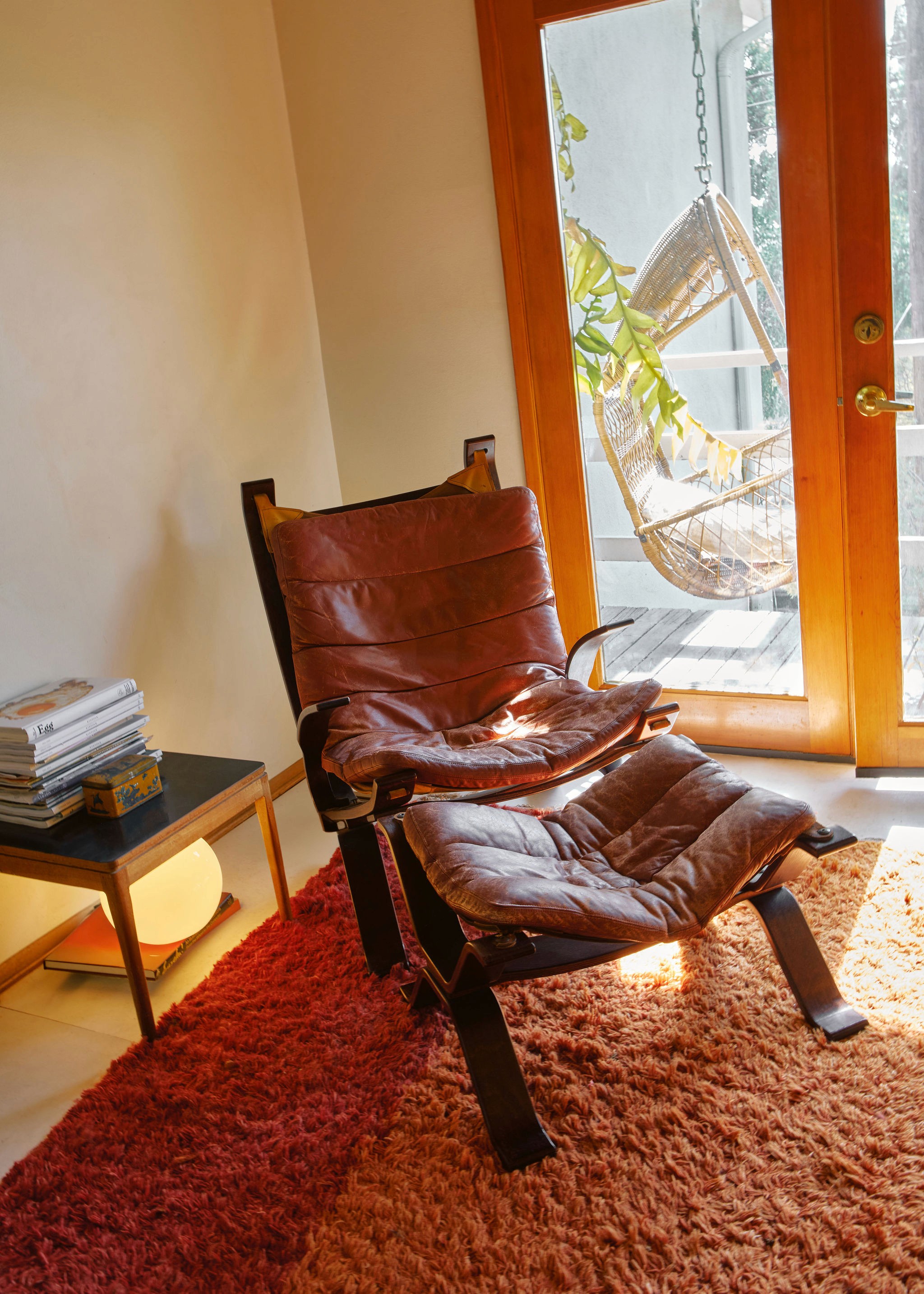Woman with large sunglasses and jewelry touching her face