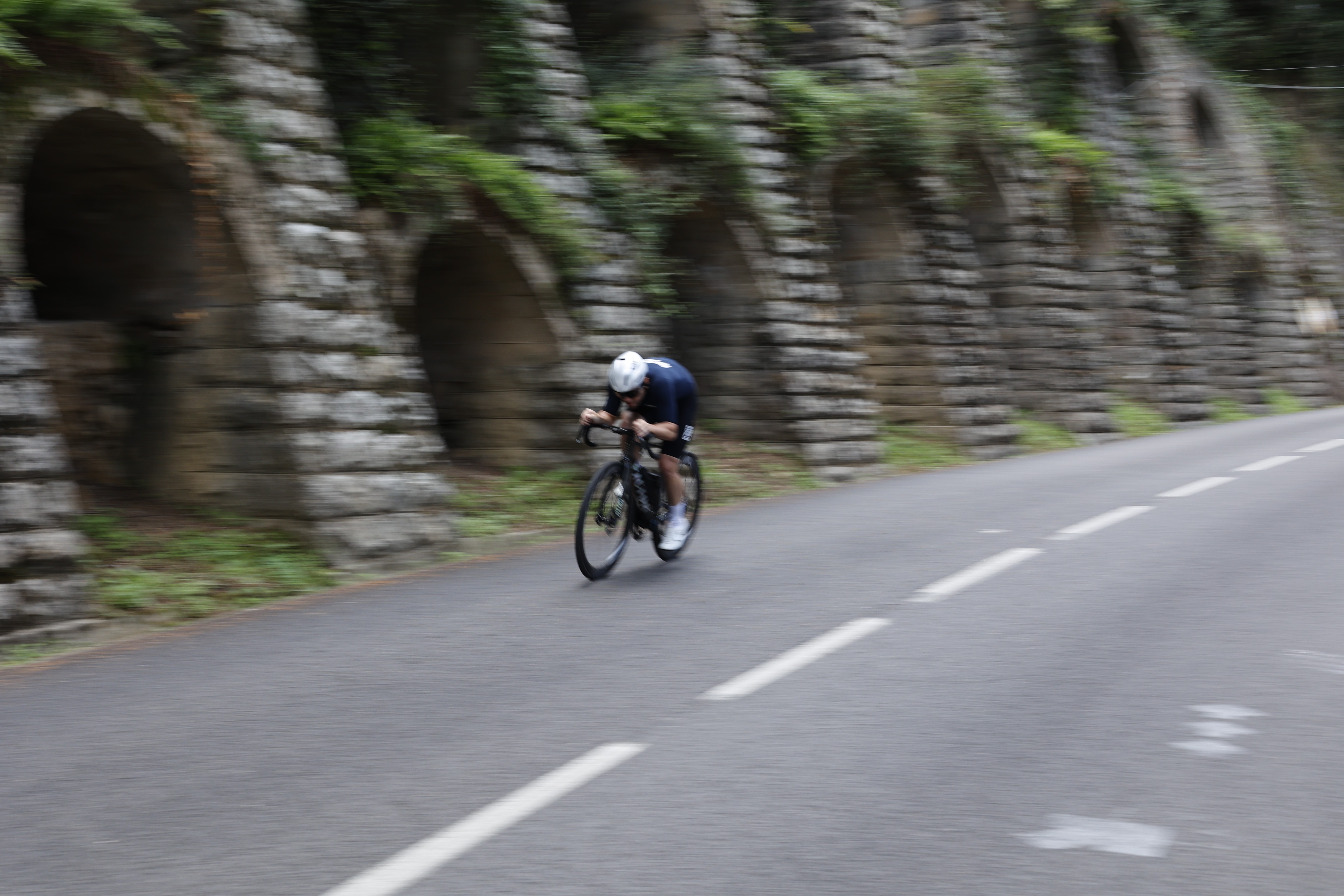 A man riding a bike down a curvy road
