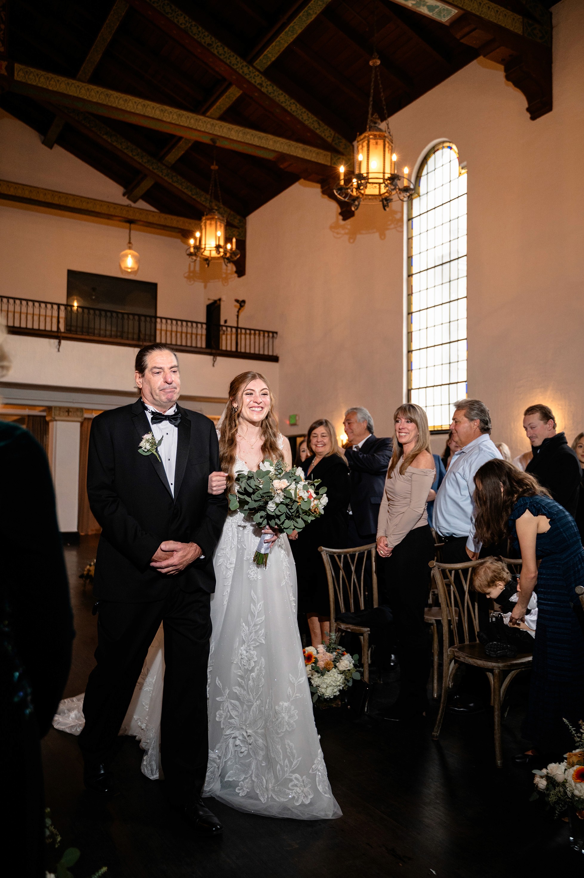 Flat lay wedding details with bouquet, rings, and sparkling bridal heels