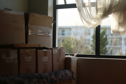 a room with boxes and a window illustrating relocation