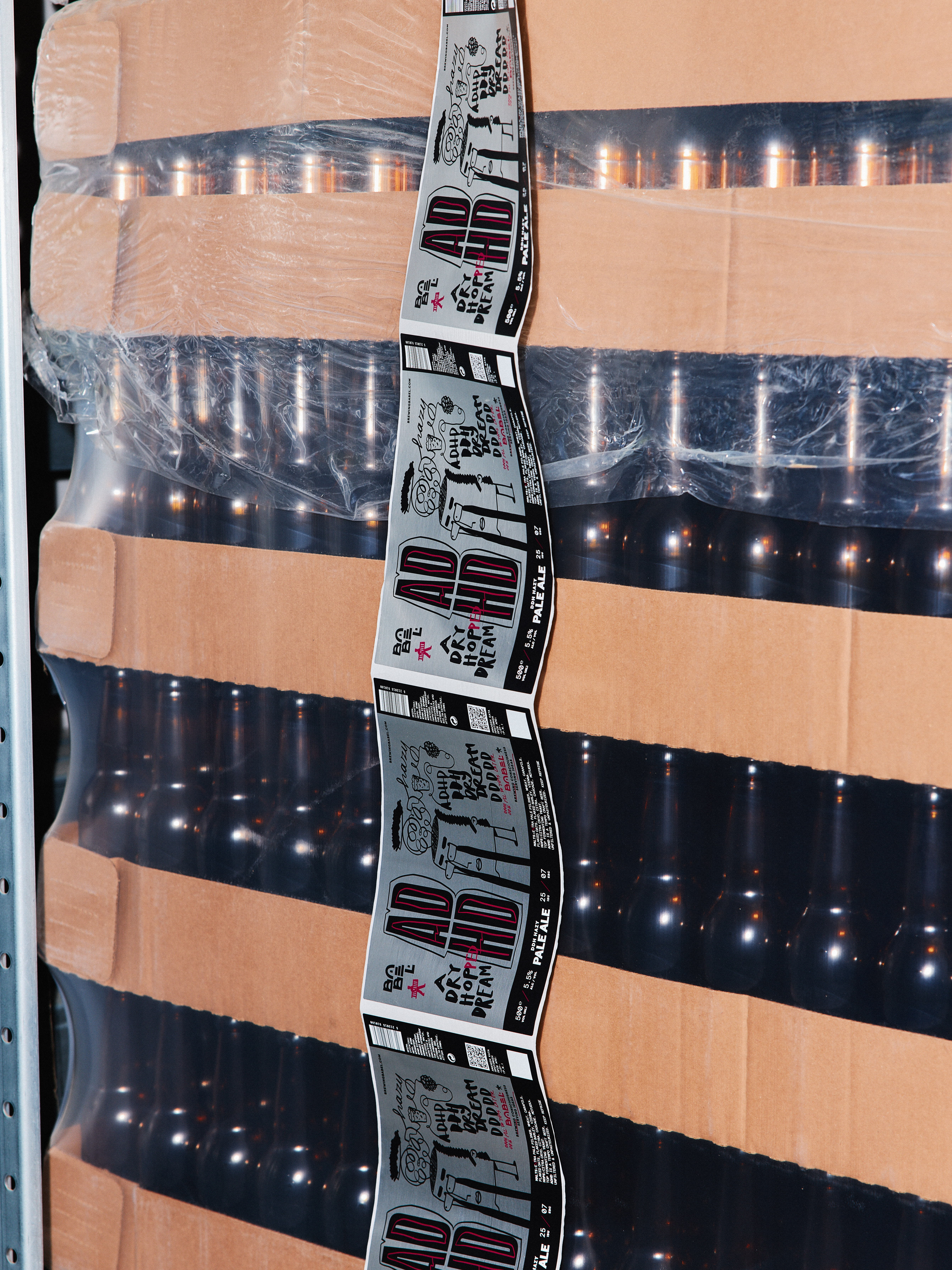 A thoughtful young person with dark hair gazes to the side, captured in soft black and white lighting.