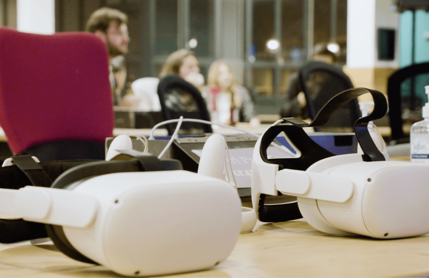 People sitting and standing near a pair of sunglasses.