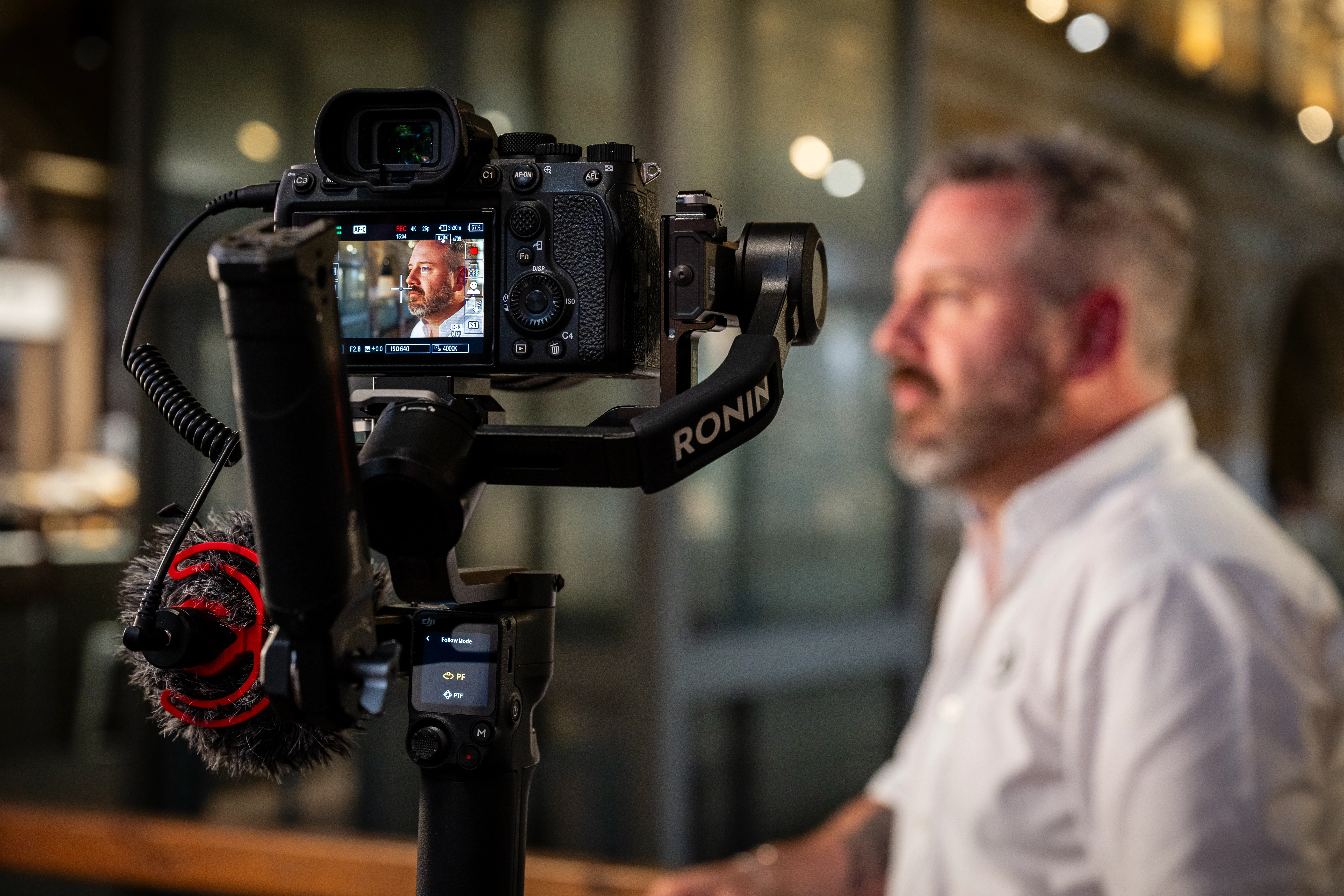 Black and white portrait of a smiling person with curly hair