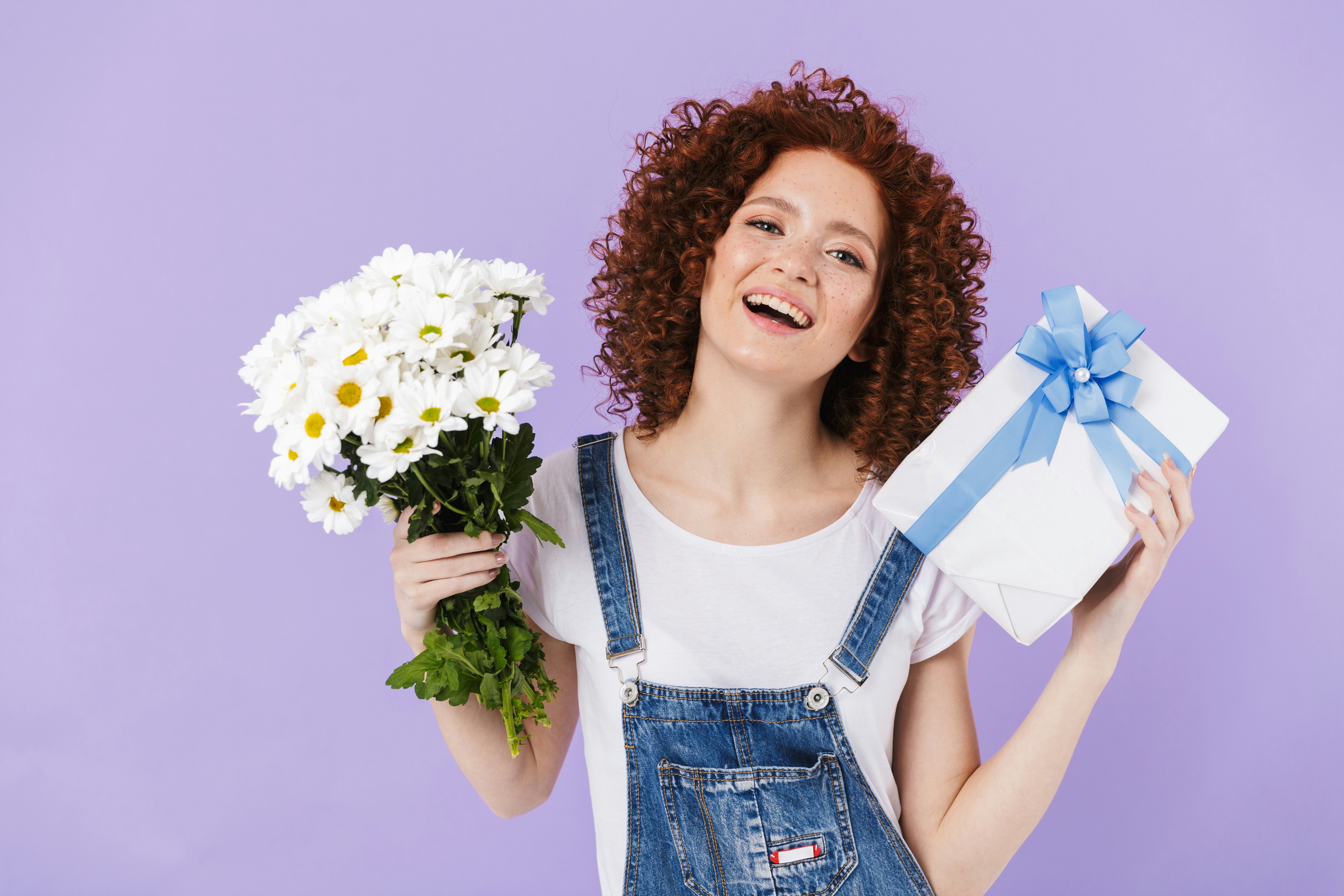 woman holding a gift and flowers - Preppy Stuff