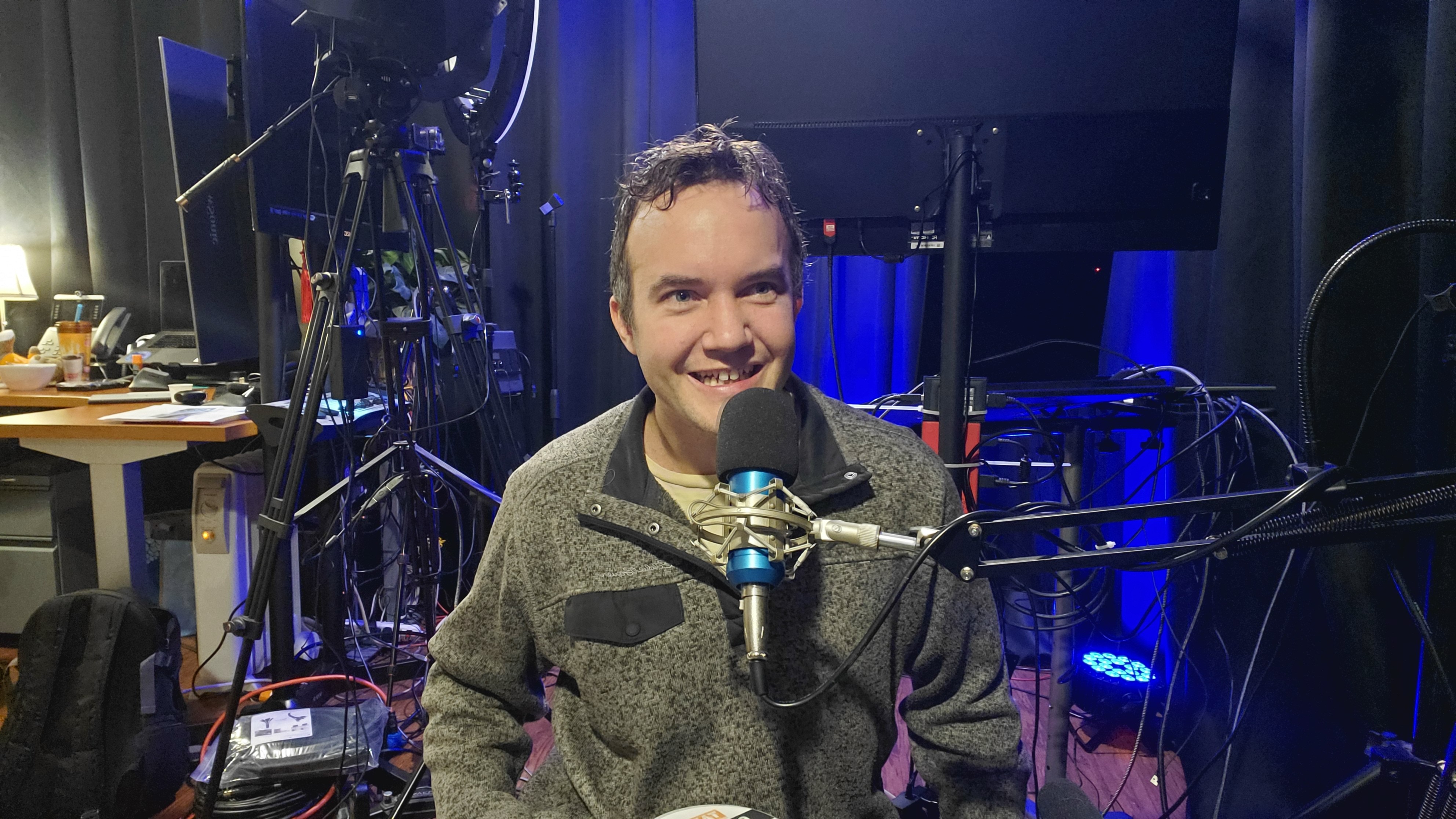 A man speaking into a microphone during a podcast