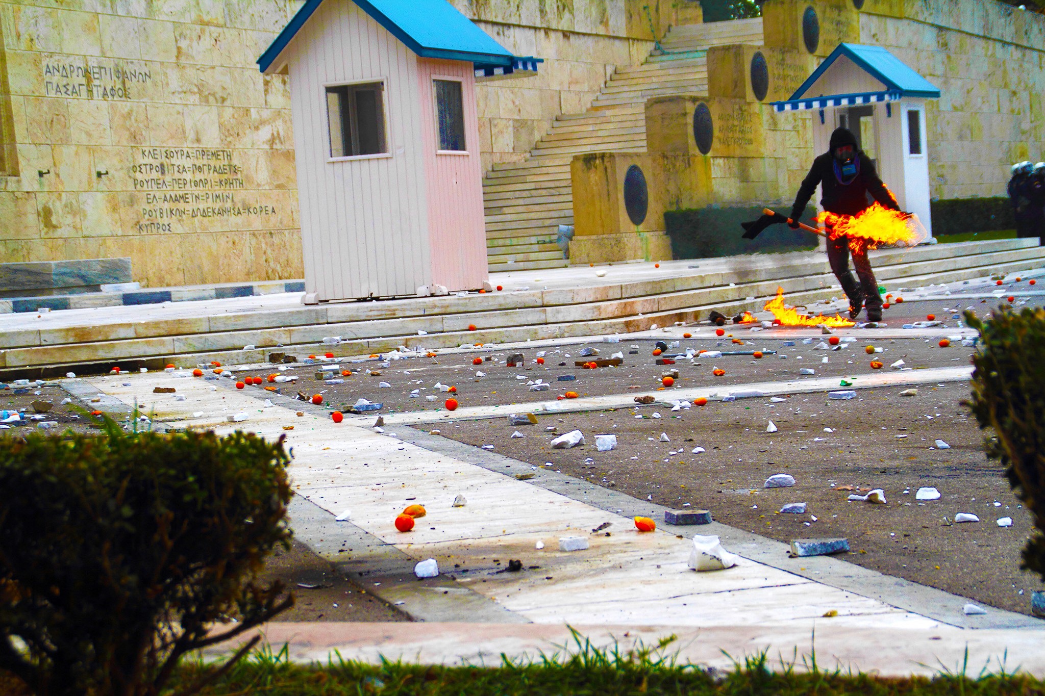 Riots in Athens, a protester is throwing a molotov cocktail. Action Photography, BBC Published