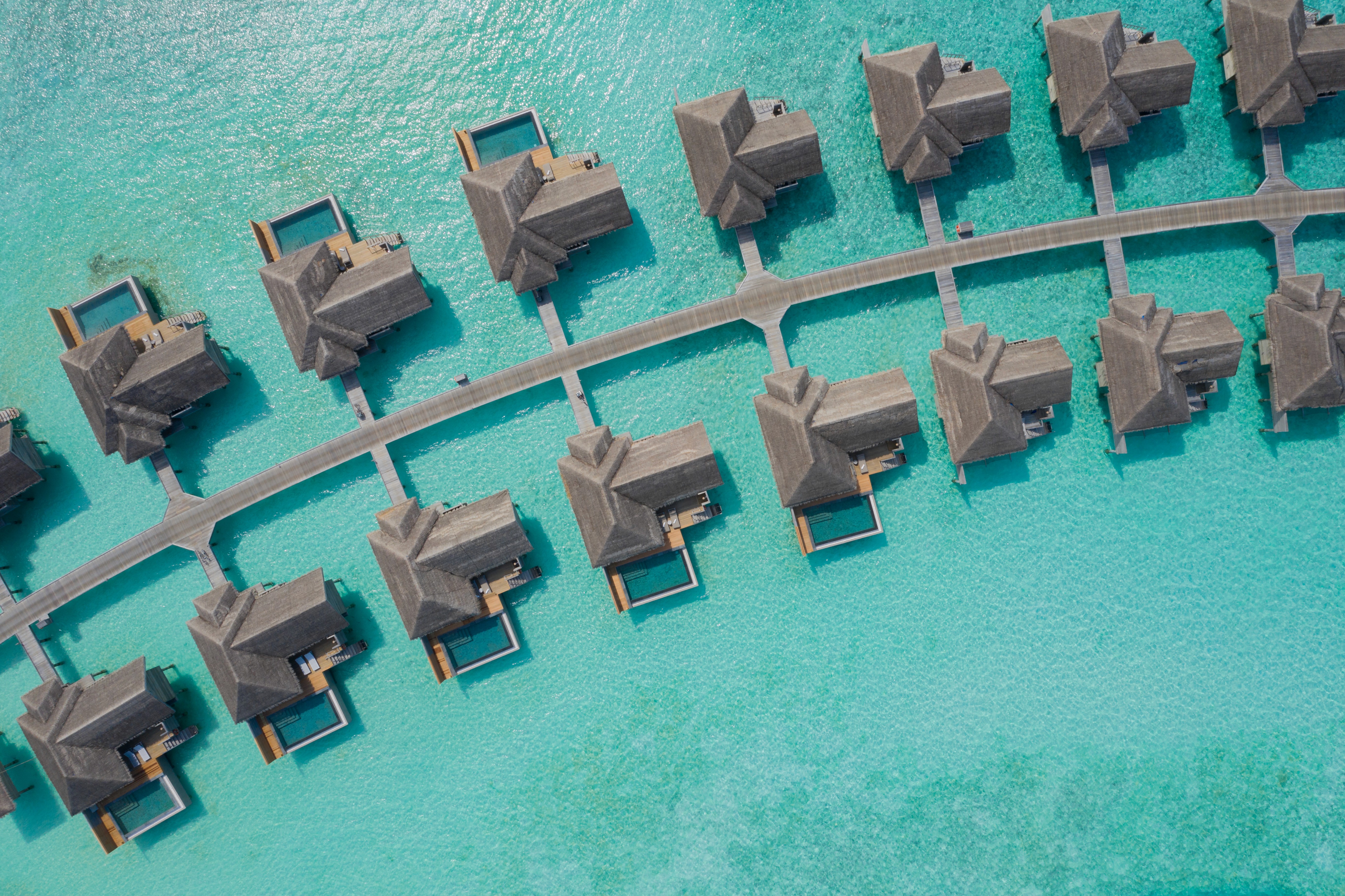 Overwater villa aerial image of a Maldives hotel with ocean