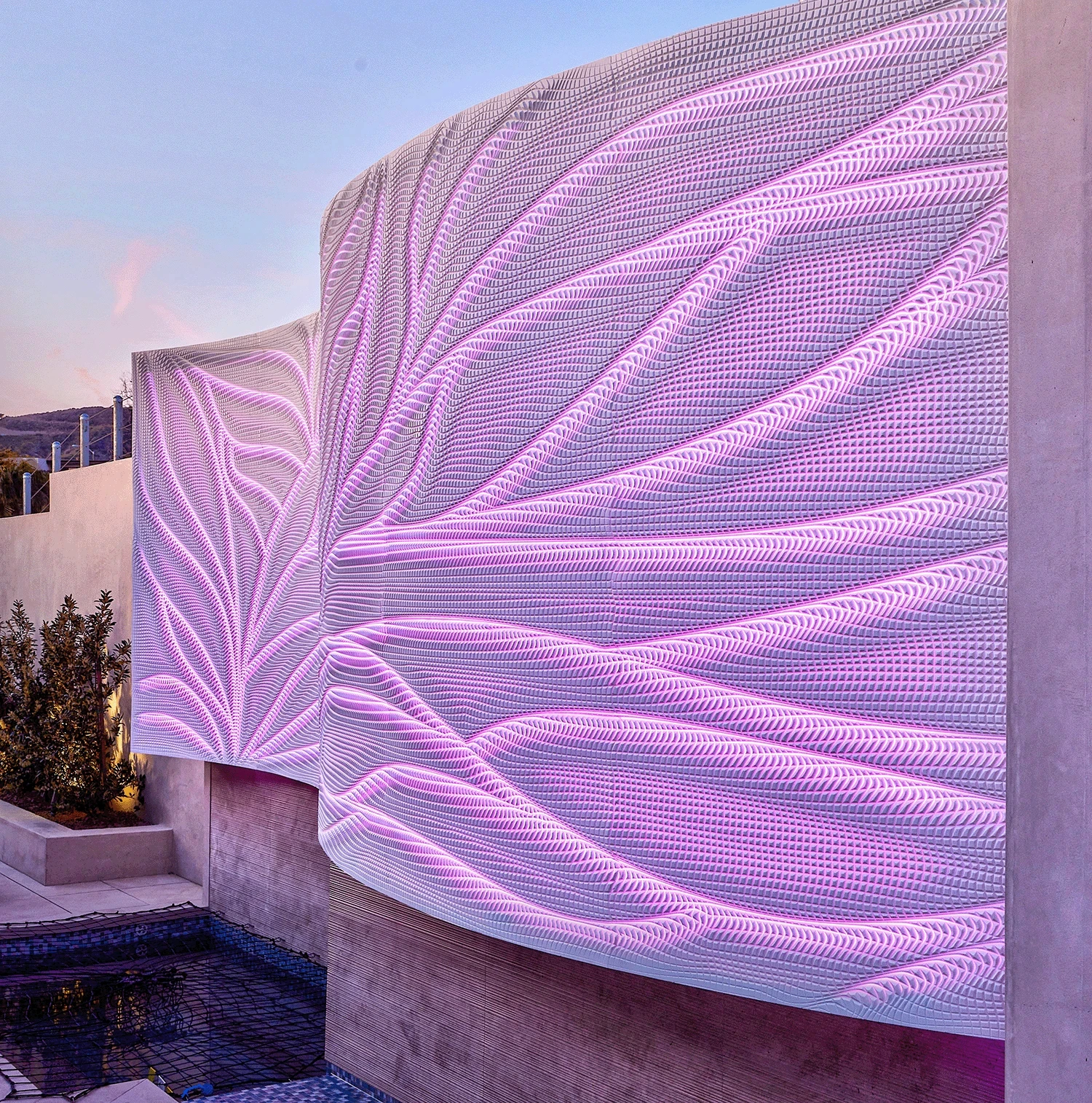 Curved exterior backlit Corian wall at a restaurant