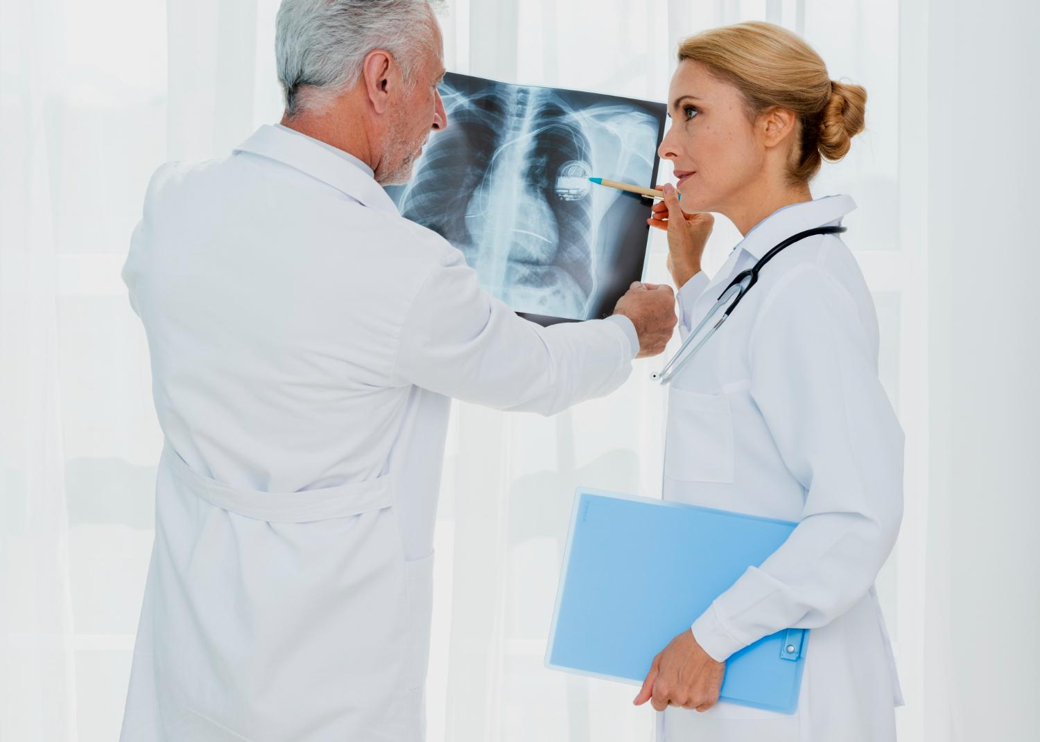 Two medical professionals examining an x-ray.