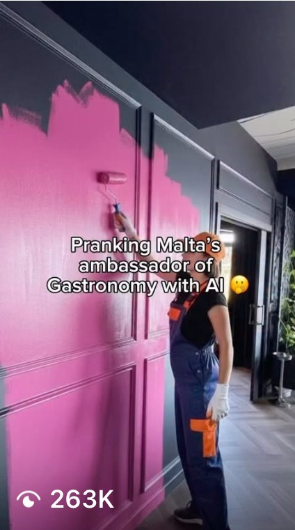 outtake from viral Instagram reel. girl painting a black wall pink.