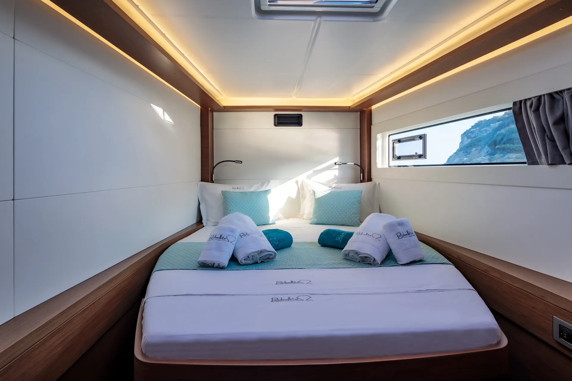 White Rock 36 speedboat with captain at helm cruising calm blue waters near Paros coastline with hills in background.