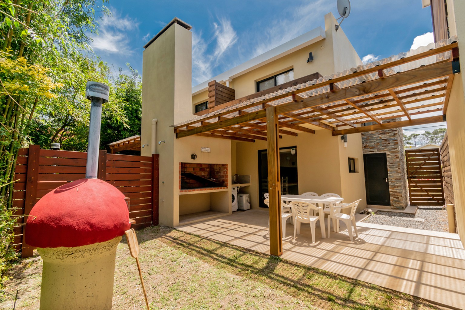 Parrillero en galería techada de Casa Gaviotas - espacio cómodo y funcional para disfrutar de un buen asado en el jardín.