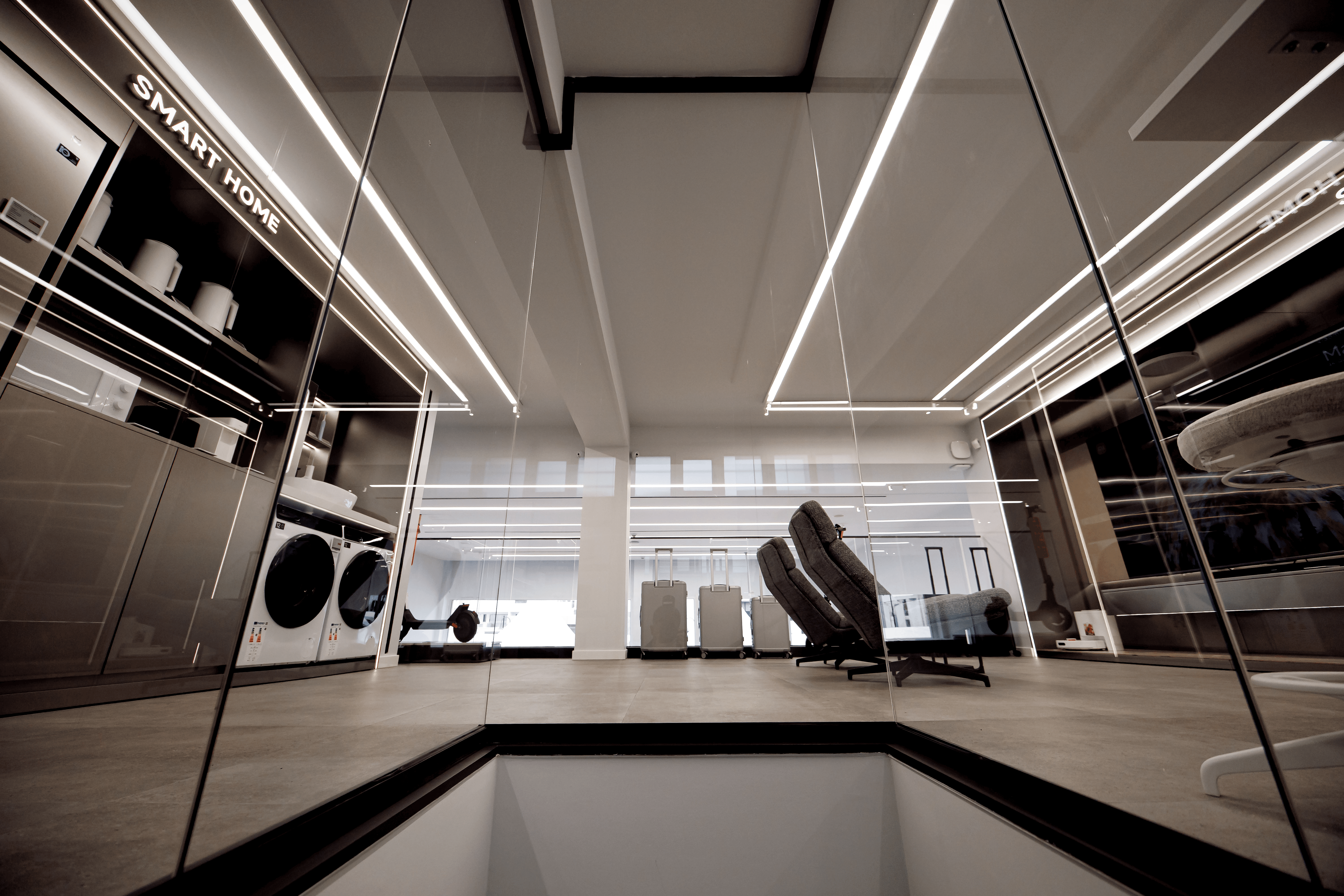 Architectural glass mezzanine and staircase in a contemporary electronics flagship Xiaomi Limassol Cyprus by topos design studio