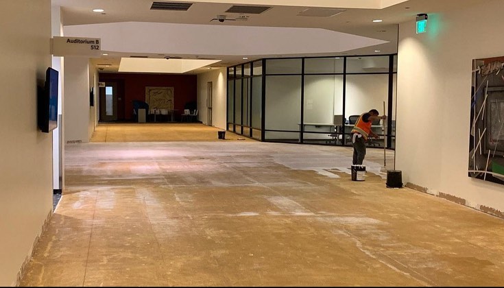 Cleared office corridor prepared for new carpet tile