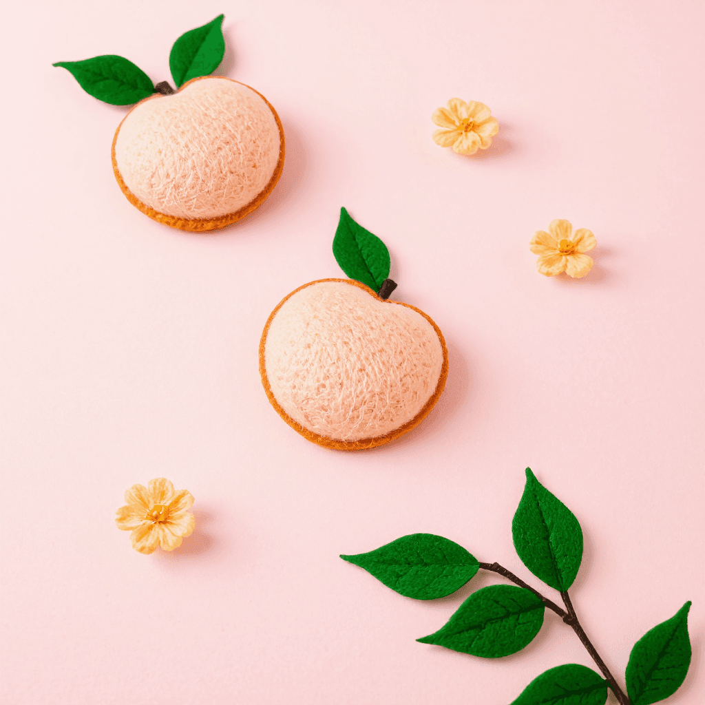 product photography of a set of peach-shaped felt decorations