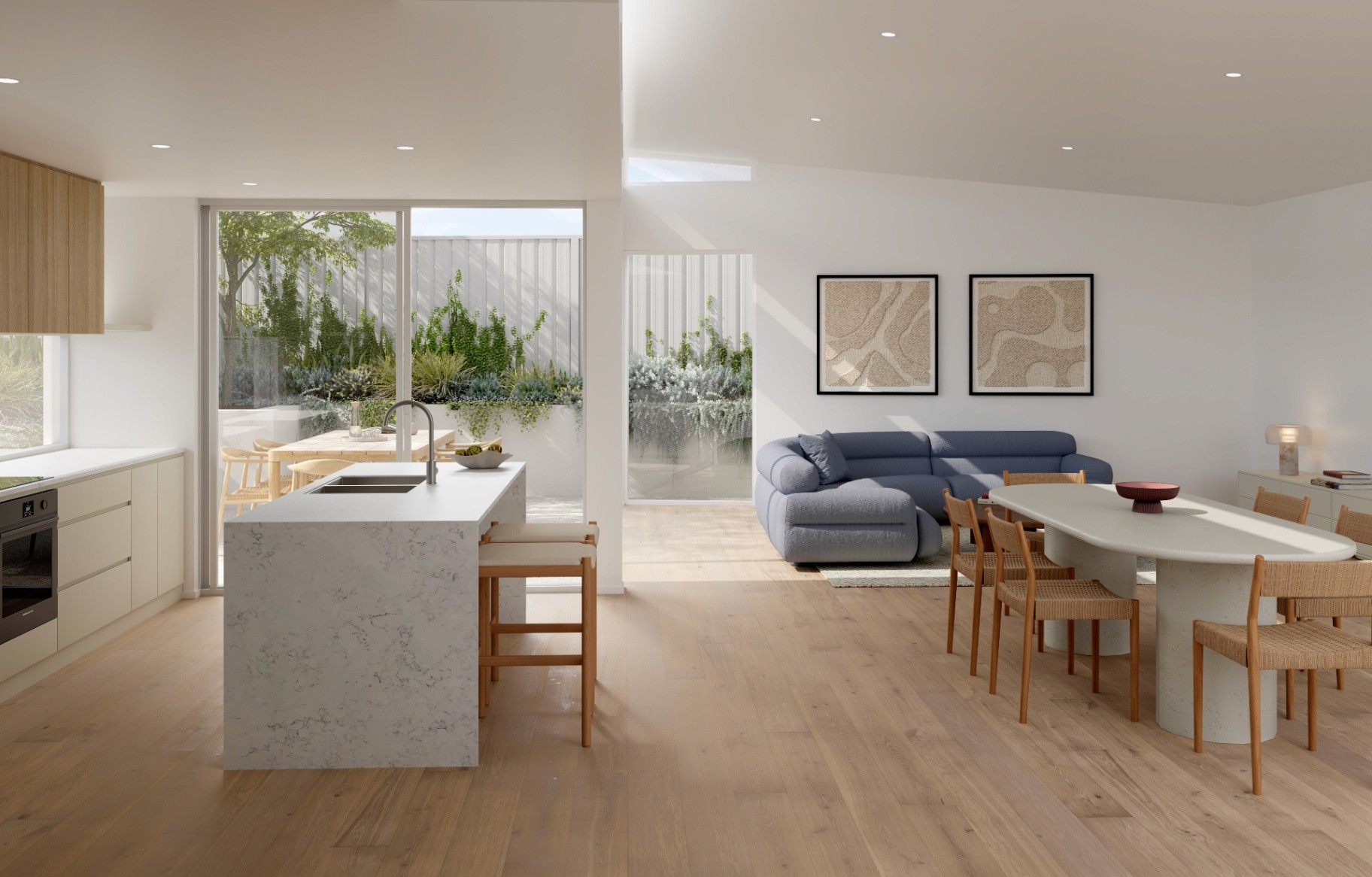 Modern open-plan kitchen with island bench, dining, and living area connected to outdoor space in a high-end Scarborough townhouse