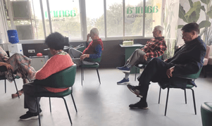 Members doing chair exercises at Aamra Seniors Club with physiotherapist