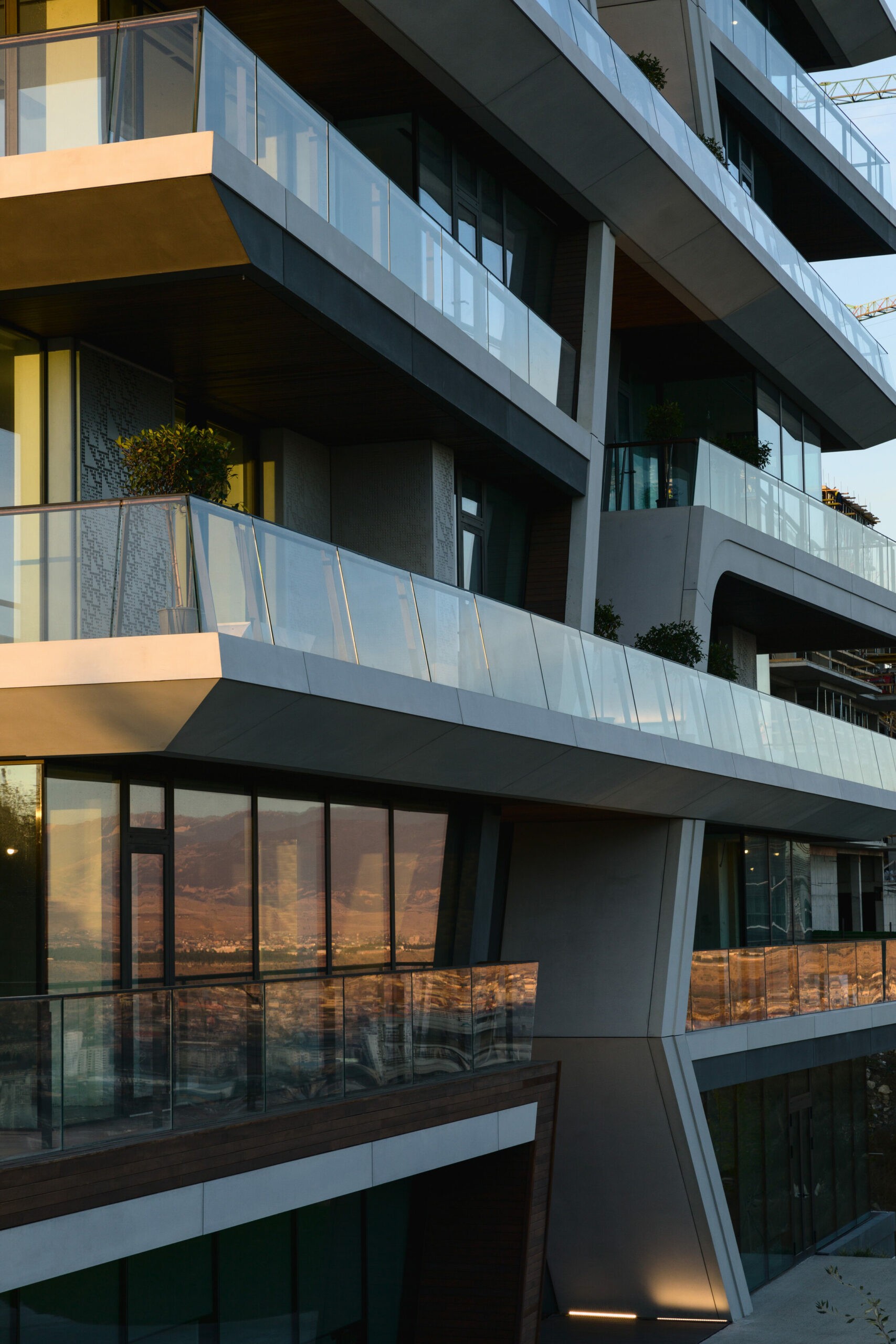 Modern architecture featuring overlapping balconies and a sleek design, creating a dynamic visual appeal.