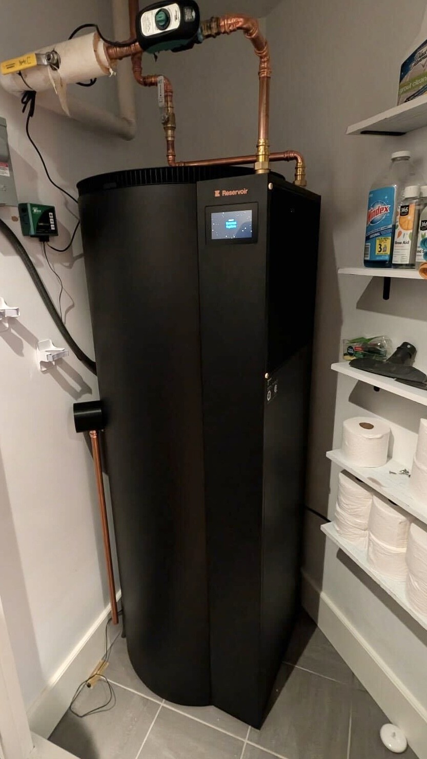 Reservoir water heater in utility closet with louvered door for ventilation