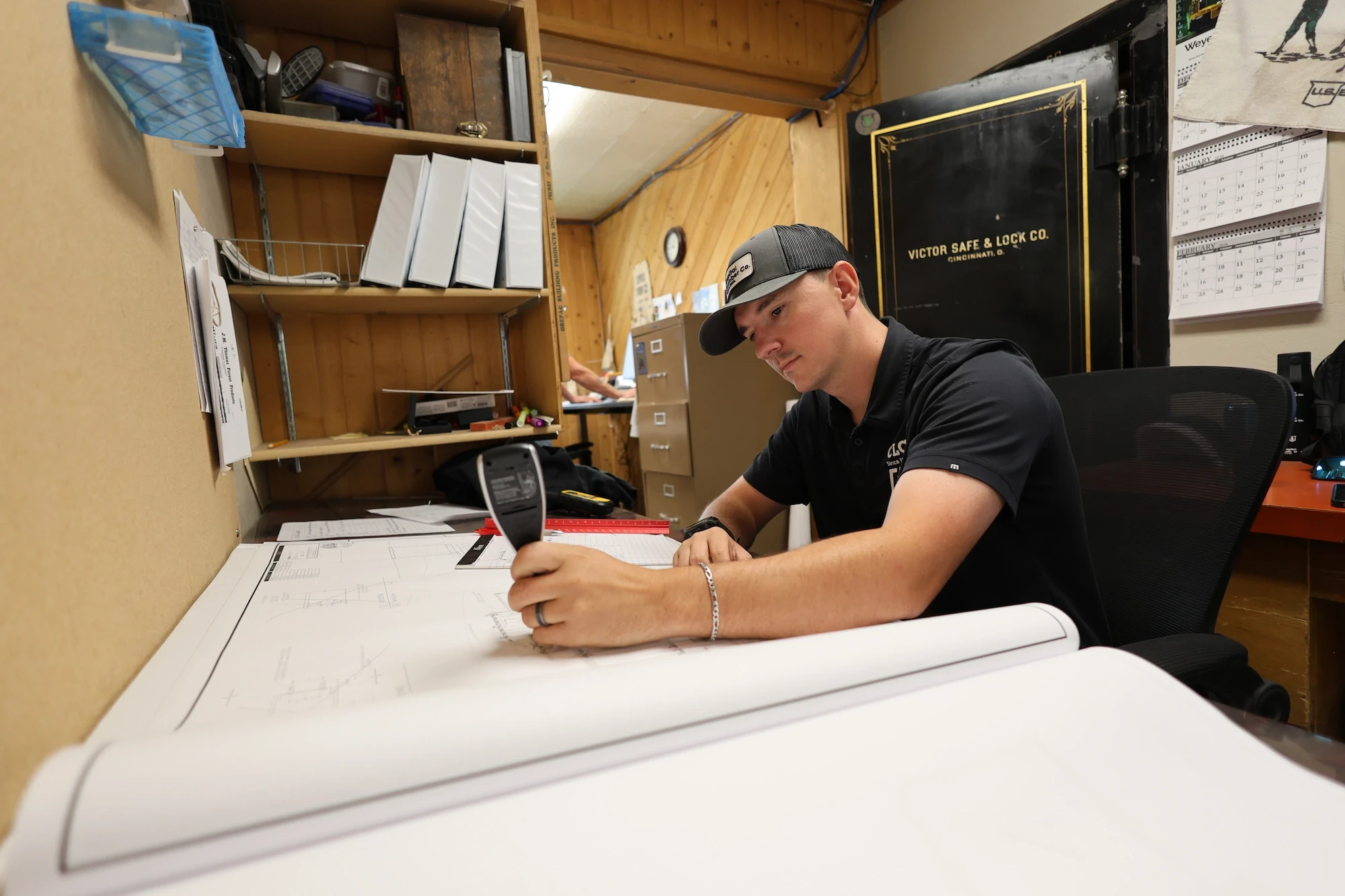 Capital Lumber employee working at the drafting desk