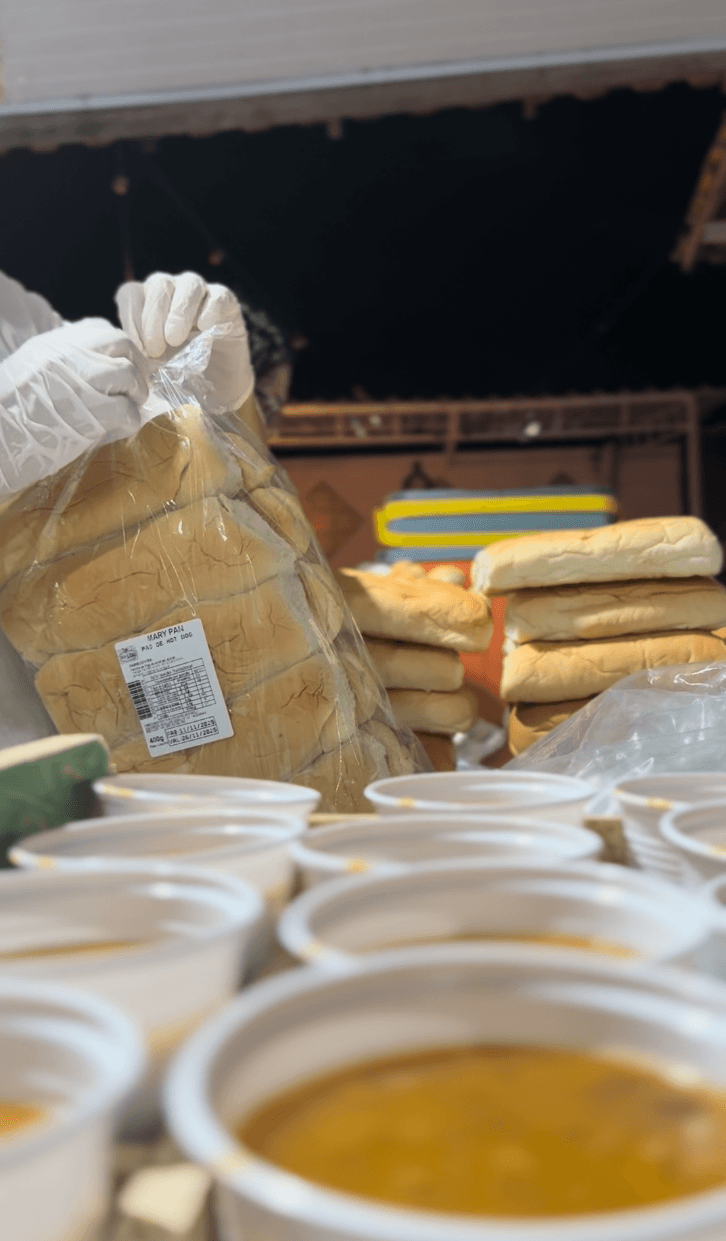 A talent recruiter with a soft smile working on her laptop in the office. The angle is on her face so we can't see what's is on the screen. She is wearing a blazer 