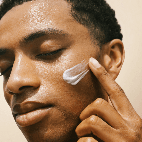 african guy using cream on chick