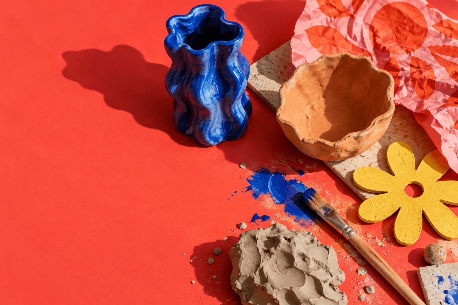 Handmade ceramics and paint on a coral worktable