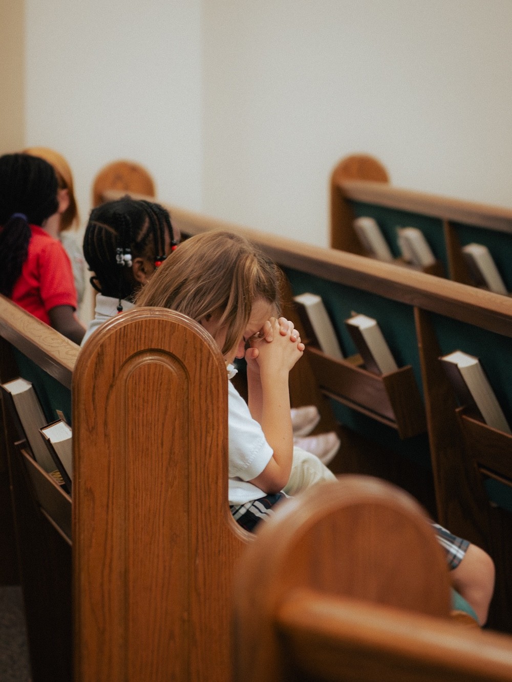 A student praying during chapel