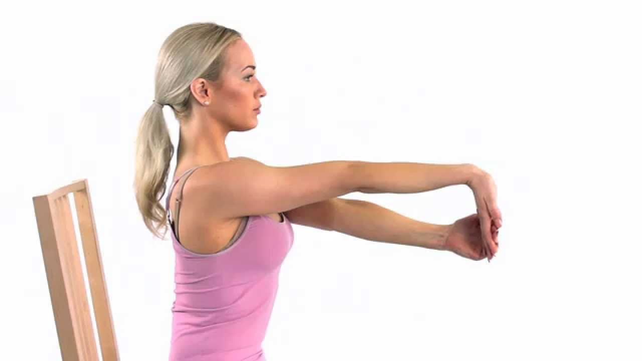 A woman performing wrist flexor stretches