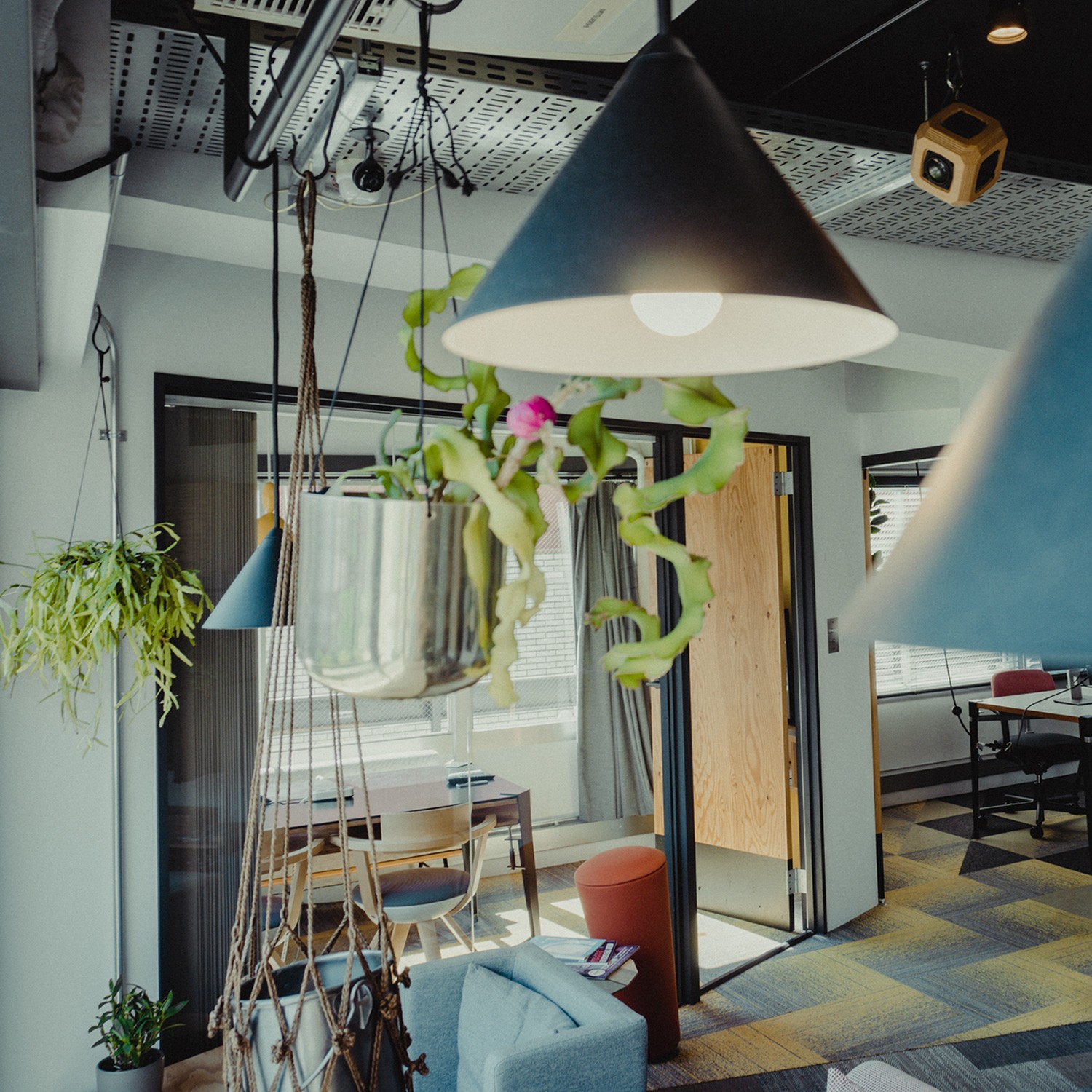 Black and white photo of two people looking at a computer screen with papers on wall