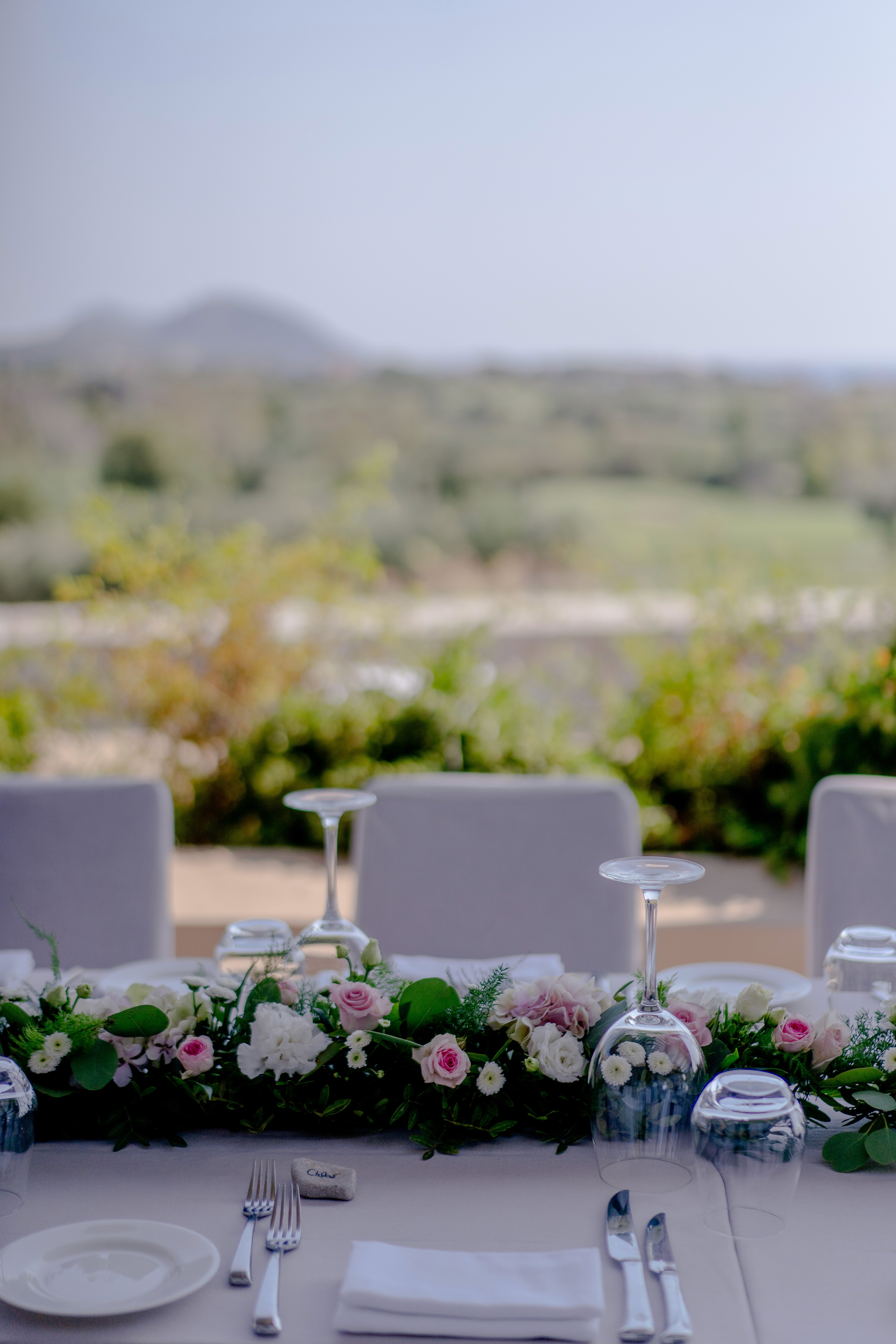 Wicker basket floral arrangement with pink roses and pampas grass for a boho wedding