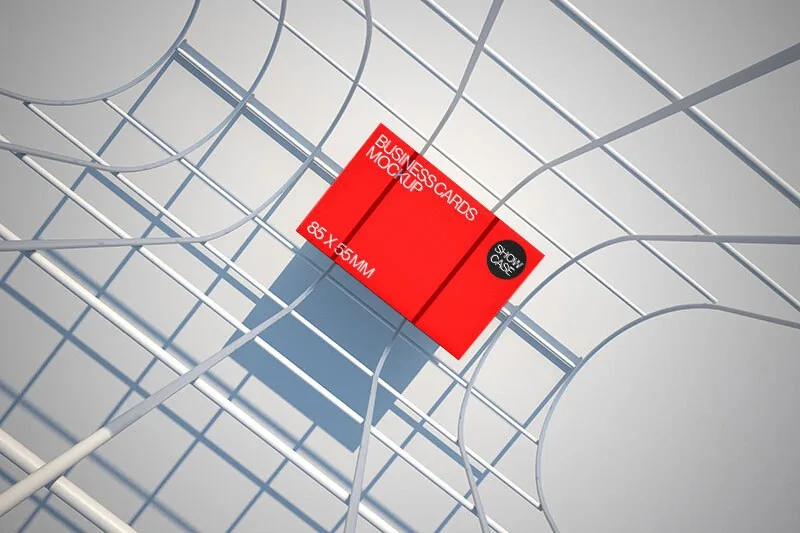 Mockup of a stack of business cards with a vibrant red cover, placed on a modern wireframe structure. The geometric shadows and light create a dynamic and contemporary presentation.