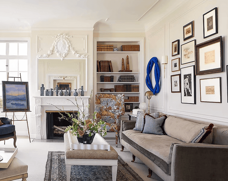 A person with short blonde hair holds a vintage camera.