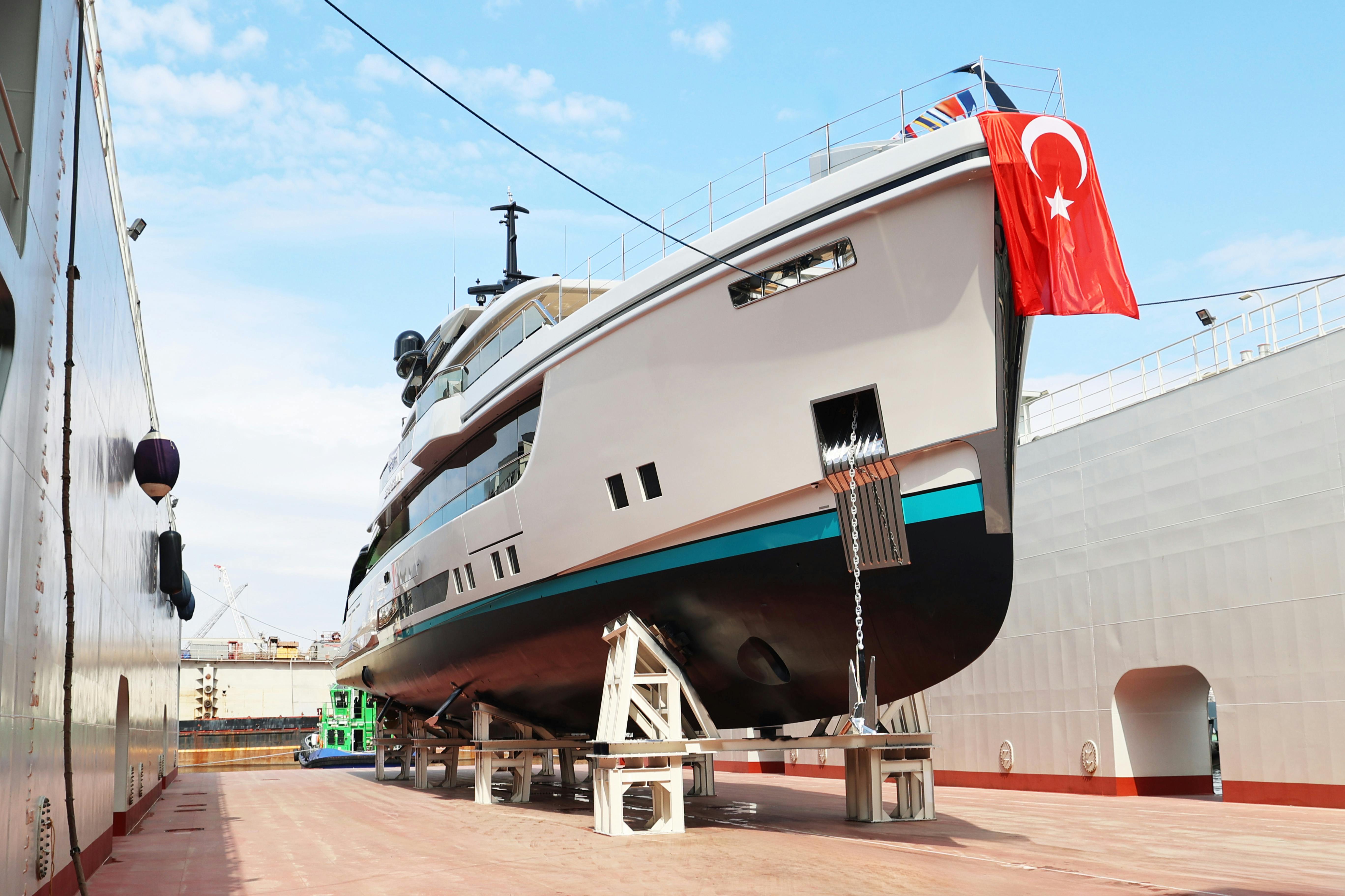 A large yacht positioned in a shipyard during construction or refit, reflecting technical processes and contractual aspects of maritime projects in Turkey