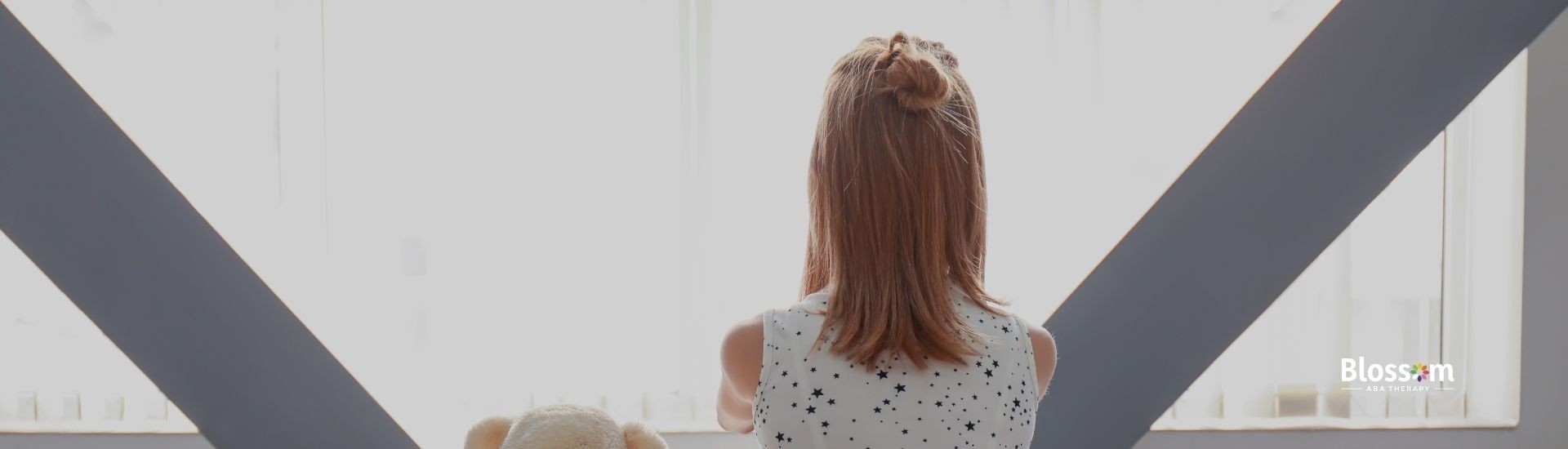 a child sit in front of the window