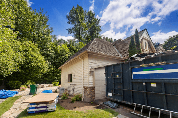 Residential roofing services in Arlington, removing old roofing materials and preparing for a complete roof replacement on a residential home.